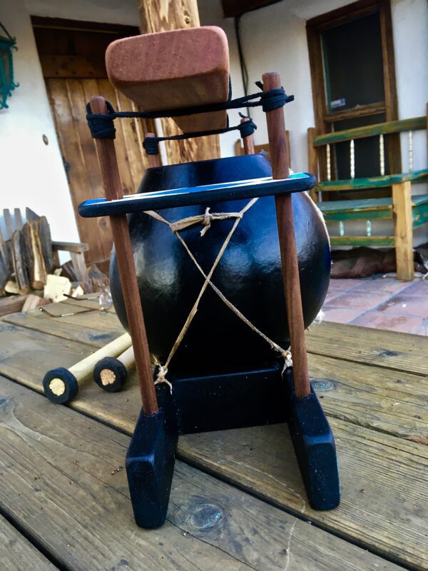 A Limba/Mbila - Ilimba Drum sitting on a wooden table.