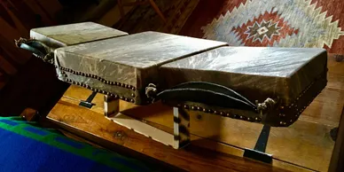 A wooden box, known as a Kalimba, sitting on top of a wooden table.