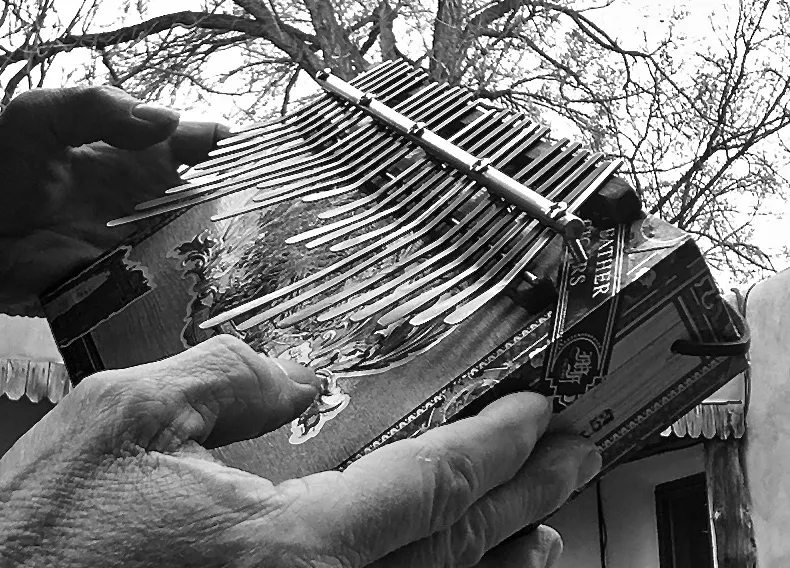 Black and white photo of a person playing an accordion.