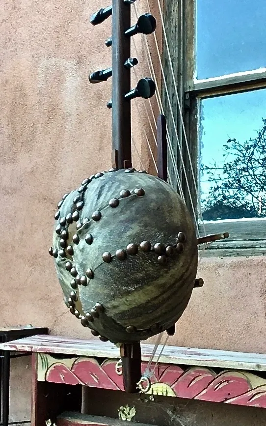 A Ngoma, a traditional African musical instrument, hangs from a window.