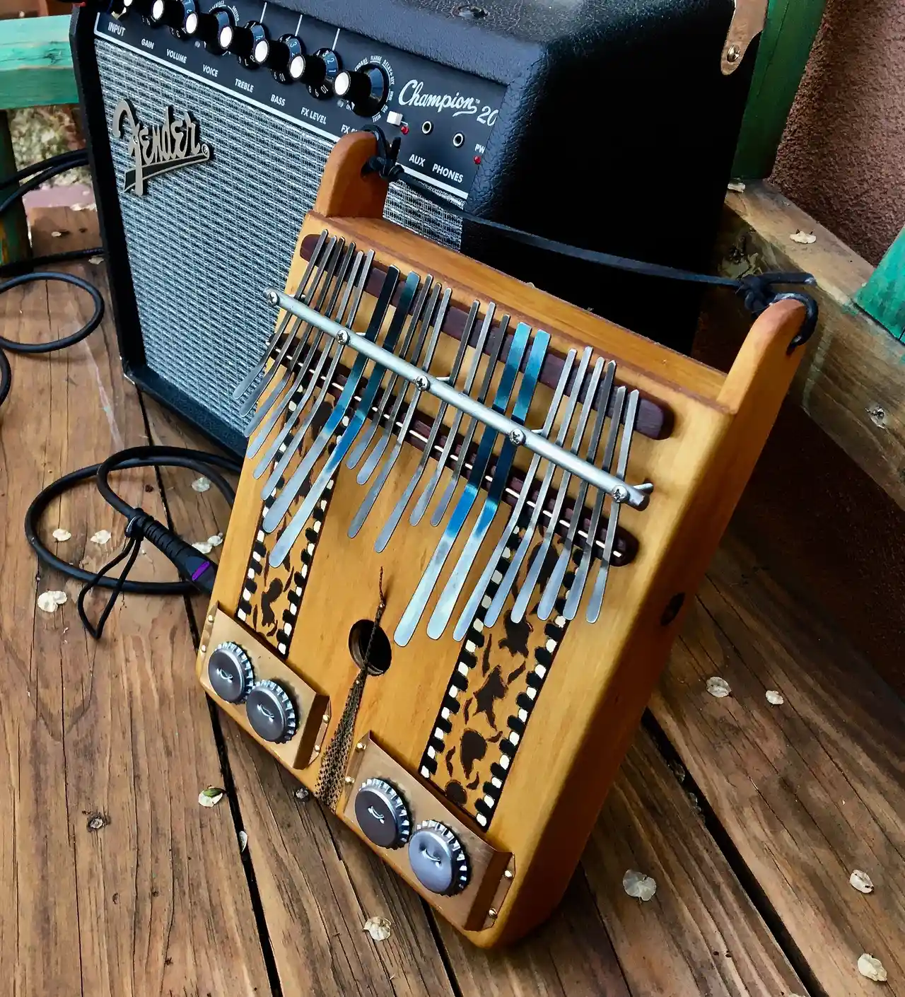 A gourd instrument is sitting on a wooden deck.