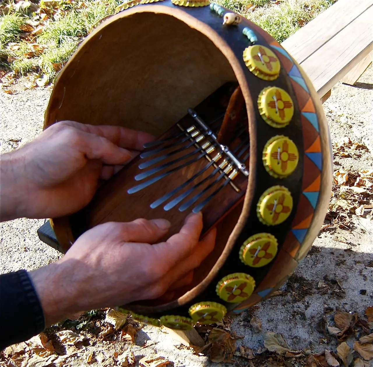 A person is playing a Ngoma drum.