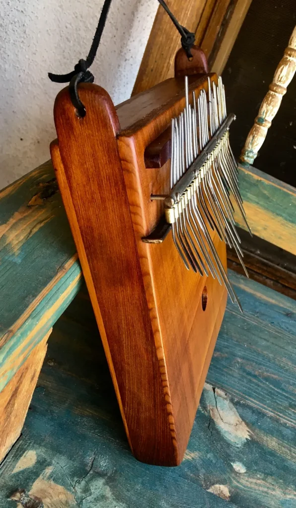 A Kongoma instrument is sitting on top of a wooden table.