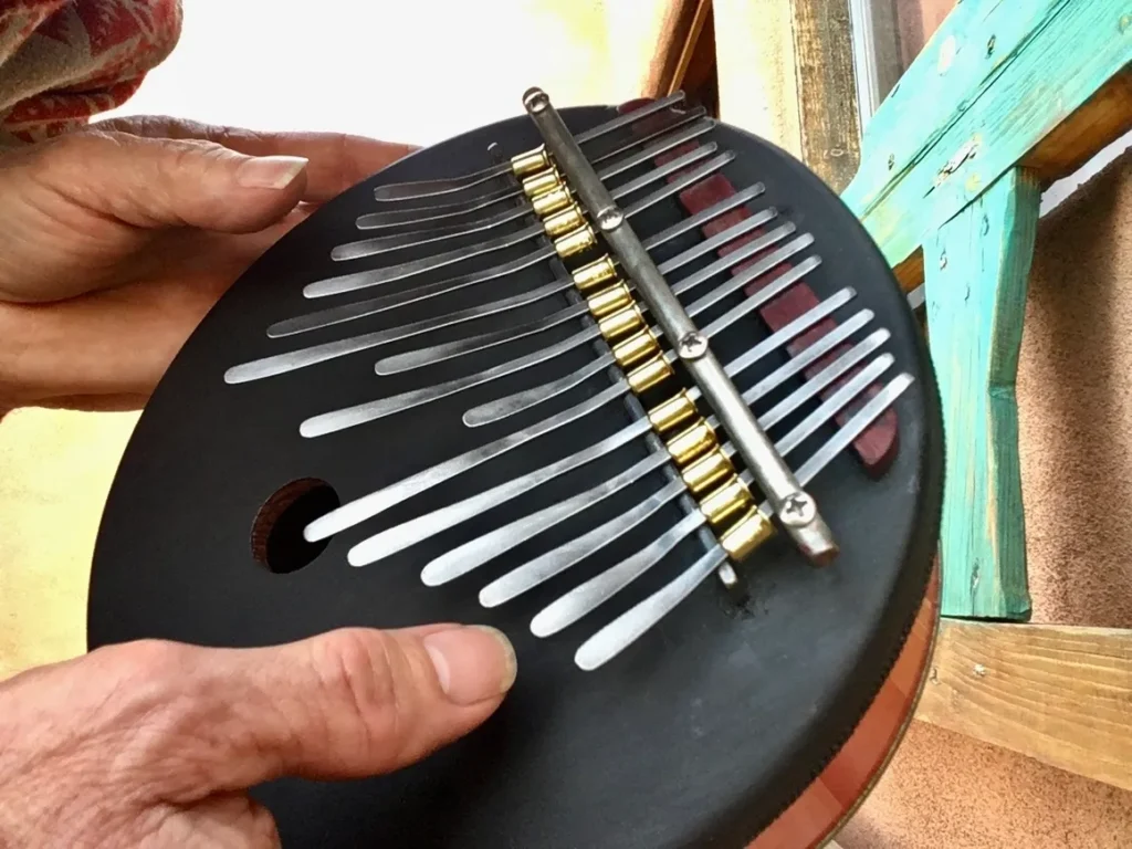 A person is holding an Ngoma, a traditional African music instrument, in their hands.