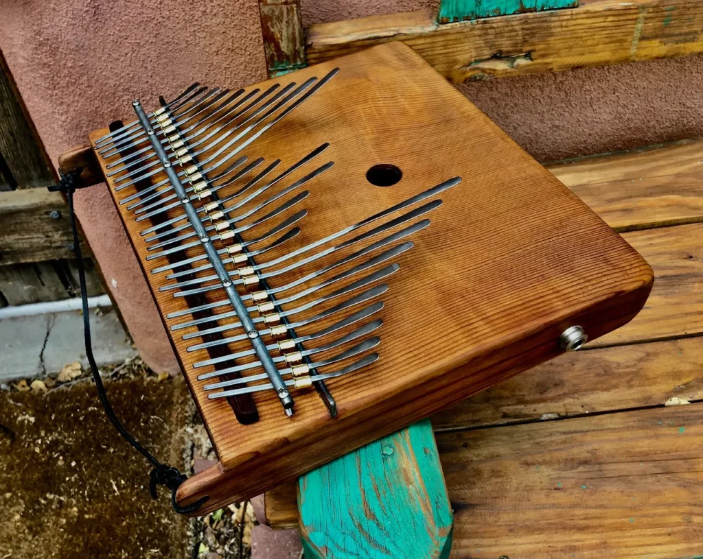 A lamellaphone sitting on top of a wooden bench.