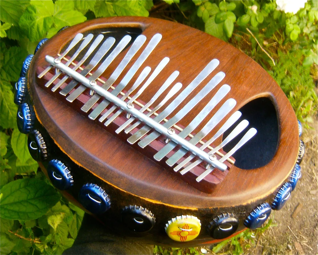 An Ilimba, a wooden ukulele with a lot of metal on it.