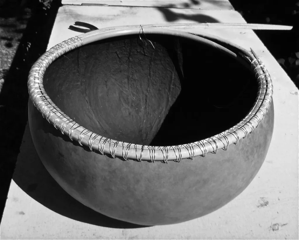 A black and white photo of a Ngoma drum on a table.