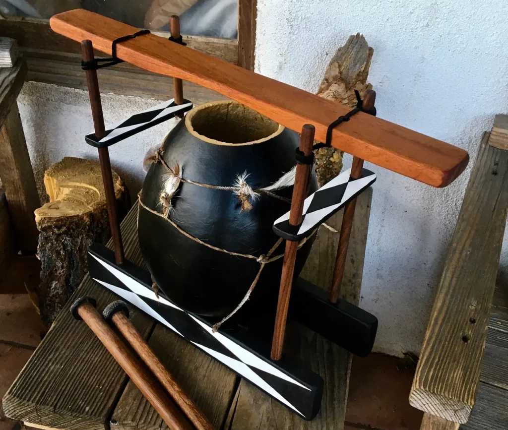 A gourd lamellaphone is sitting on a wooden table.