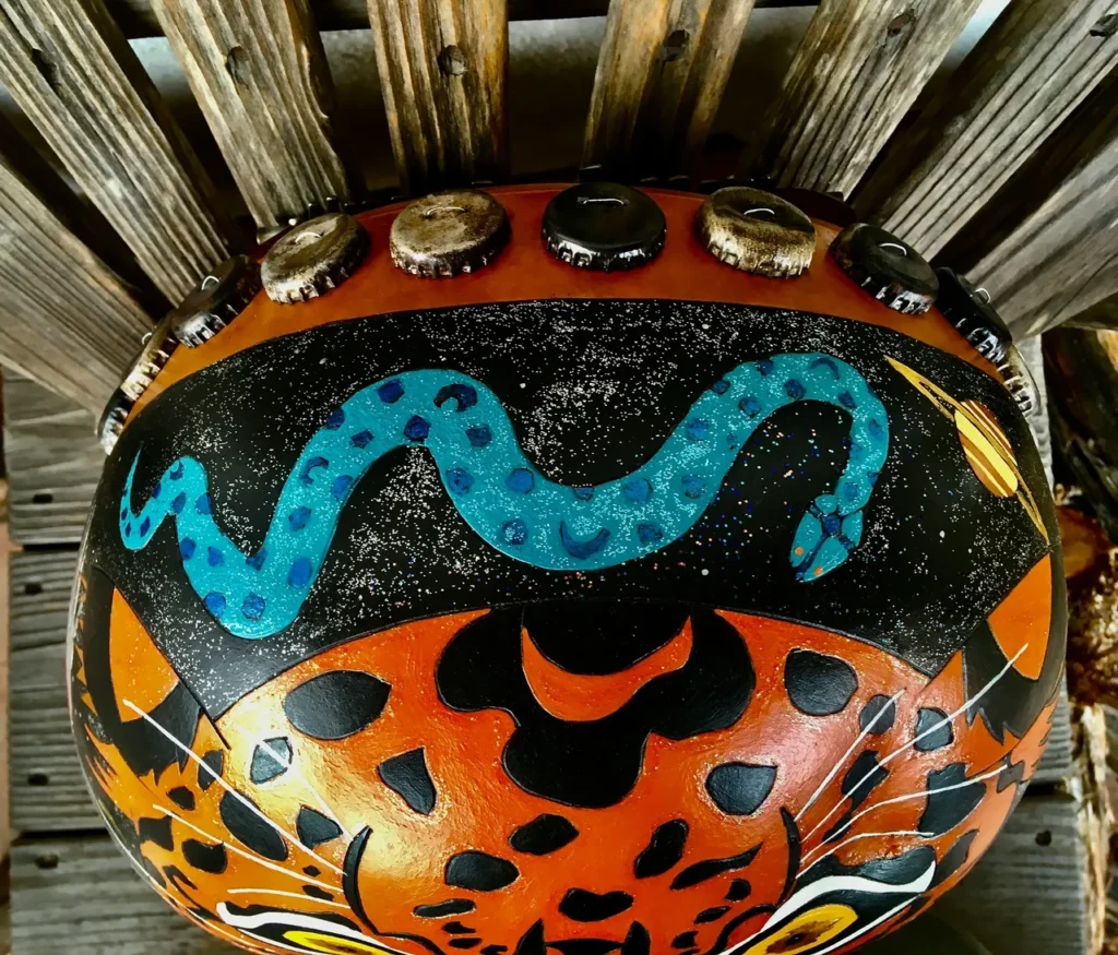 An Ilimba drum with a snake painted on it.