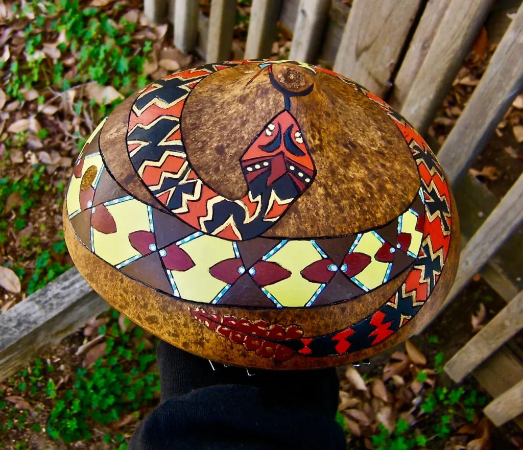 A person is holding a coconut while enjoying the vibrant beats of African music.