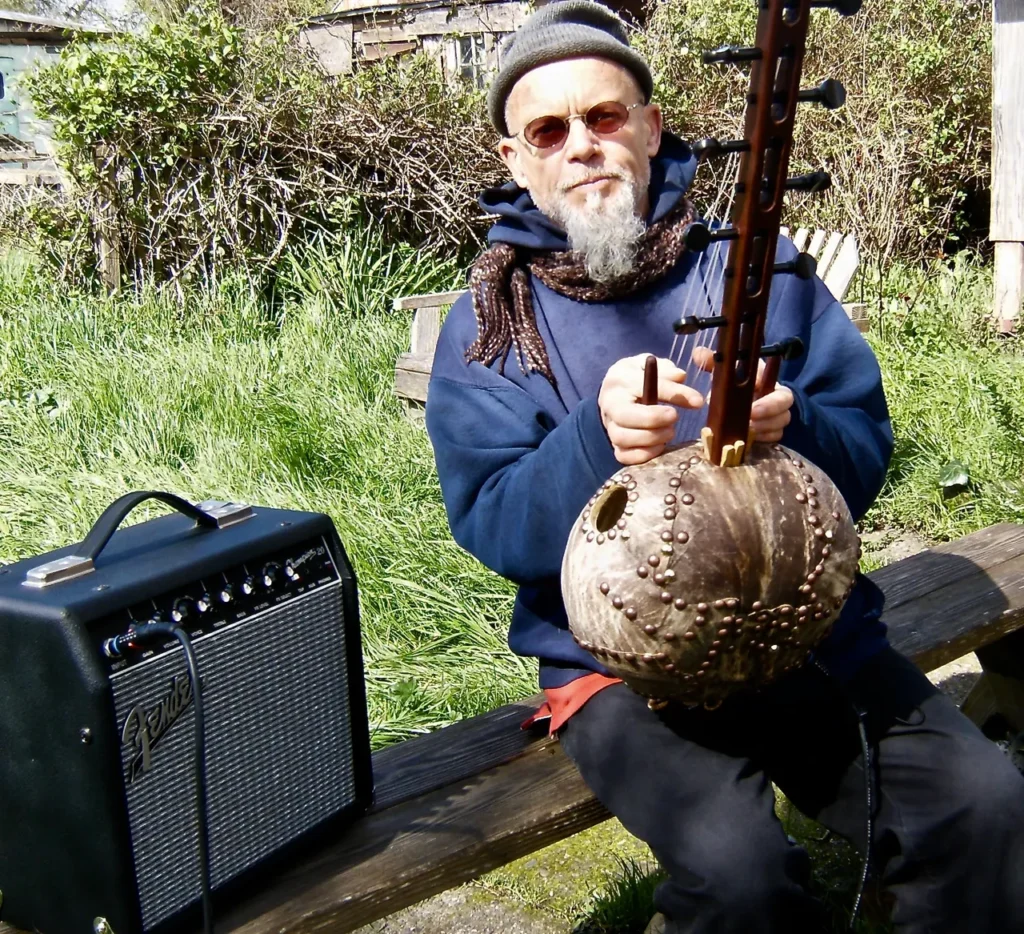 A man listening to Ngoma, African music, while sitting on a bench.