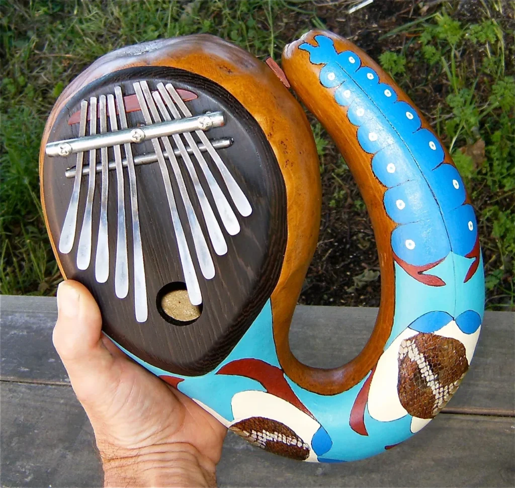 A person playing an African ukulele (Ngoma) made of wood, producing enchanting African music.