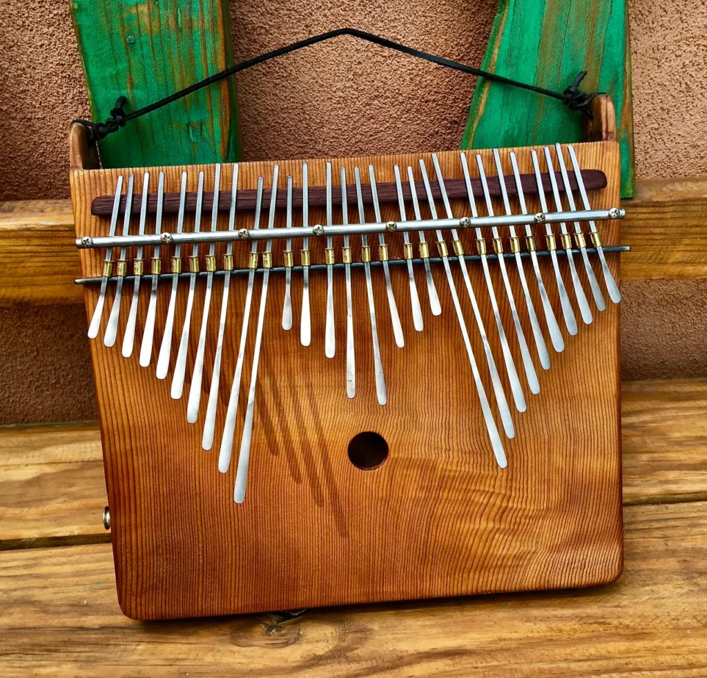 A wooden xylophone, also known as a lamellaphone, sitting on a wooden bench.