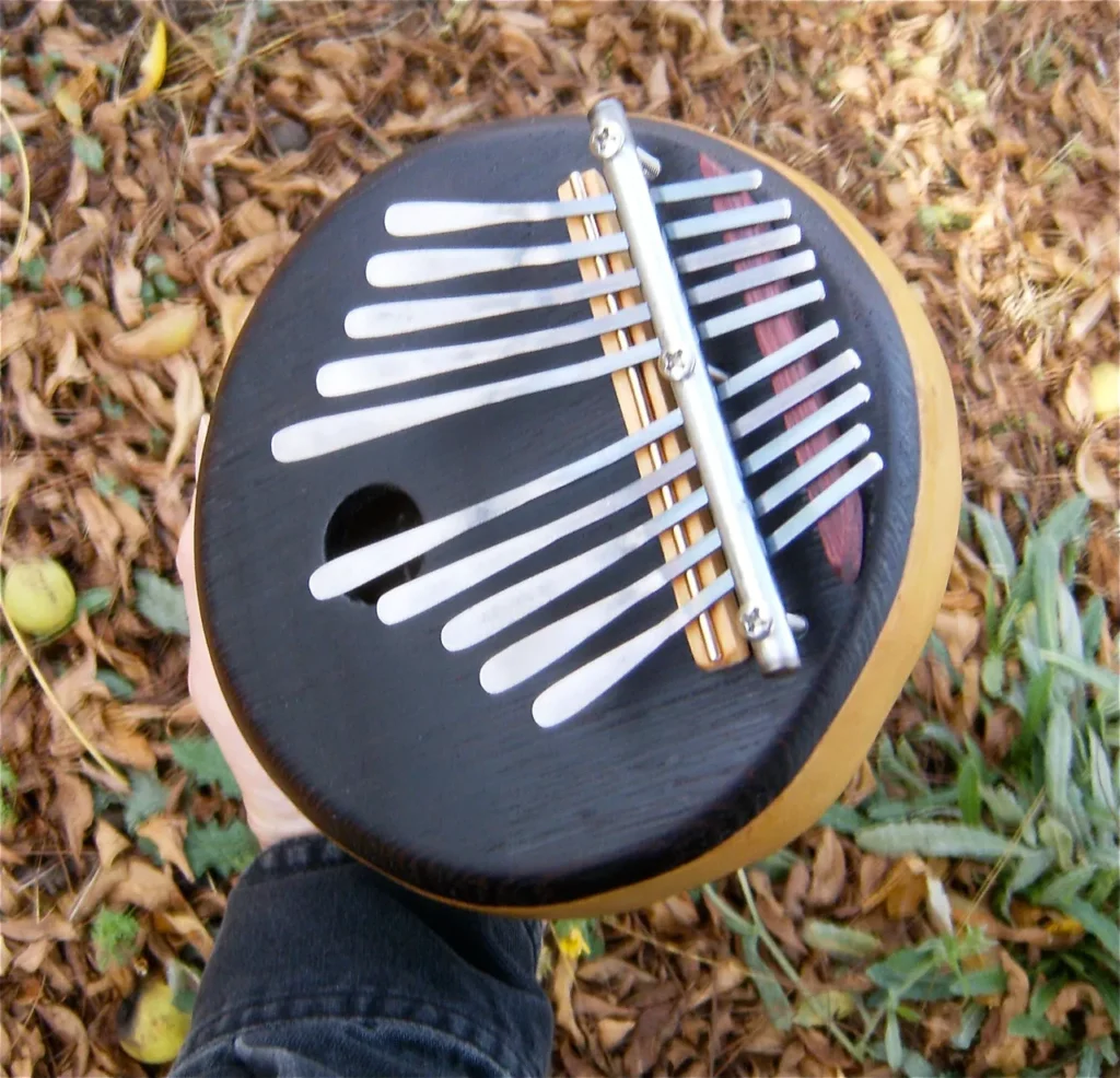 A person holding a Ngoma, a wooden African musical instrument.