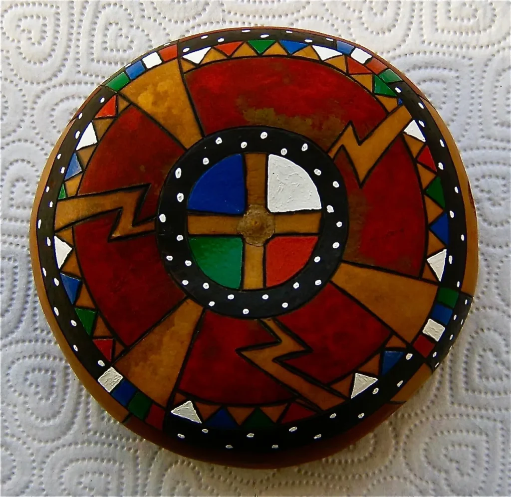 A rock adorned with a beautifully painted cross, showcasing the cultural aesthetics of Ngoma or African music.