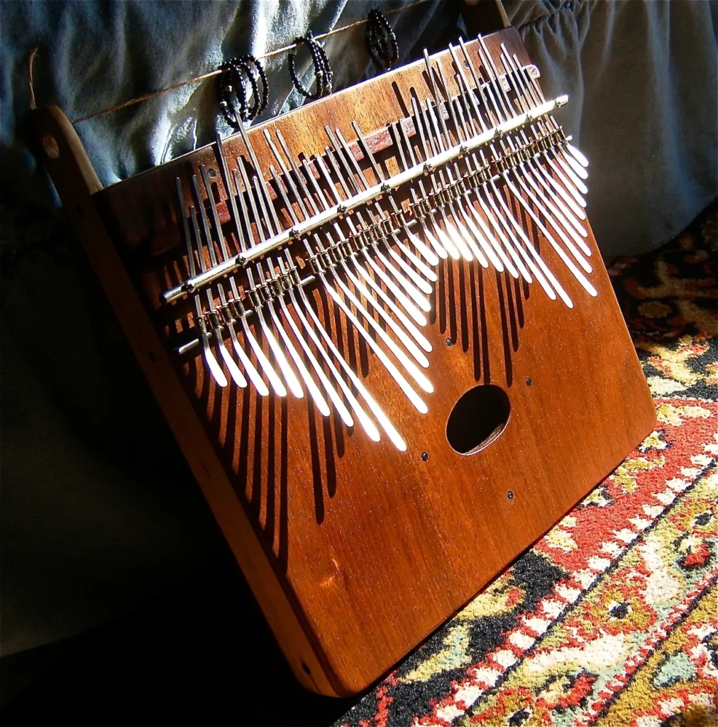 A Kongoma instrument is sitting on a bed.