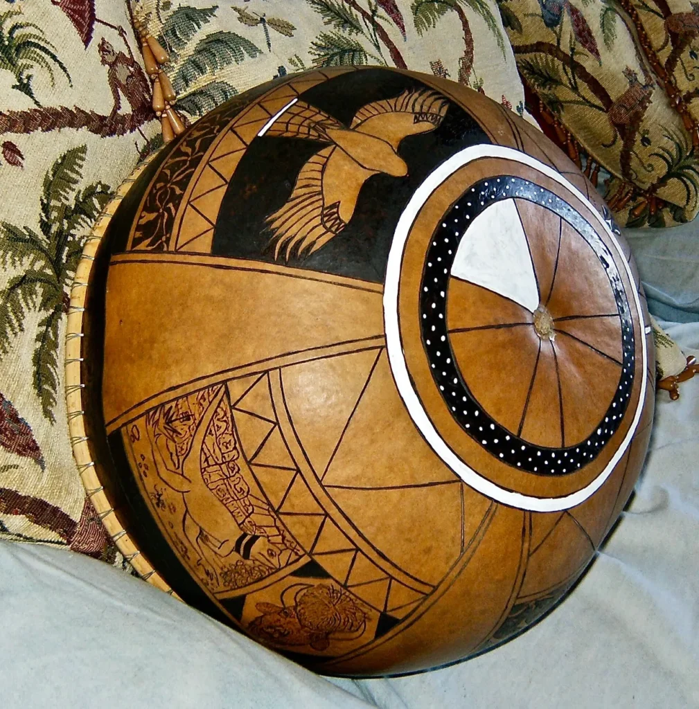 A pillow on a bed with a drum, representing Ngoma - traditional African music.