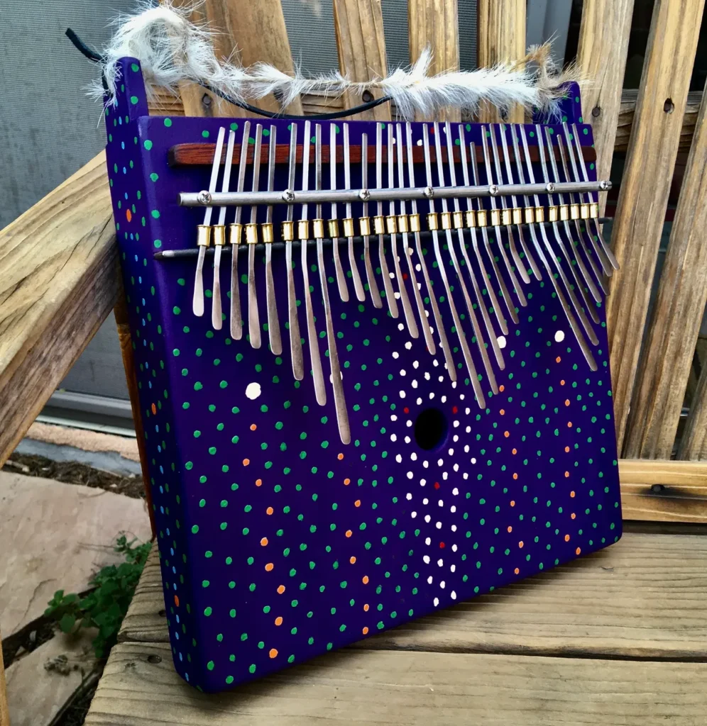 A blue and purple Kongoma on a wooden bench.