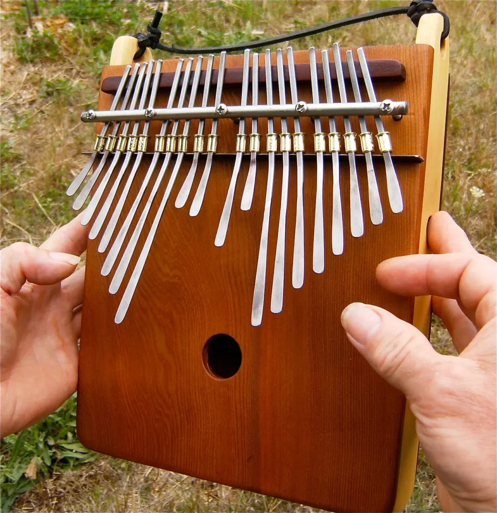 A person playing a Ngoma, a traditional African wooden xylophone.