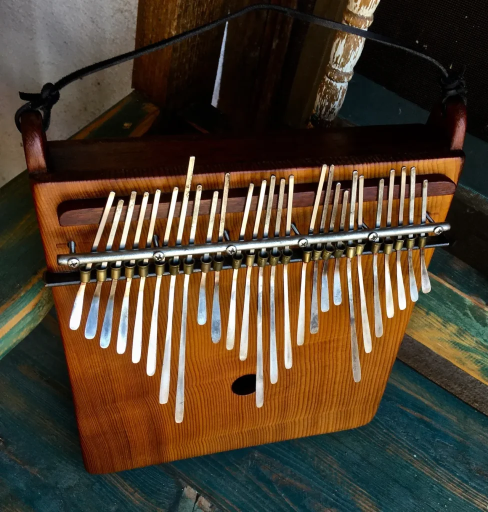 A Kongoma xylophone sitting on a wooden table.