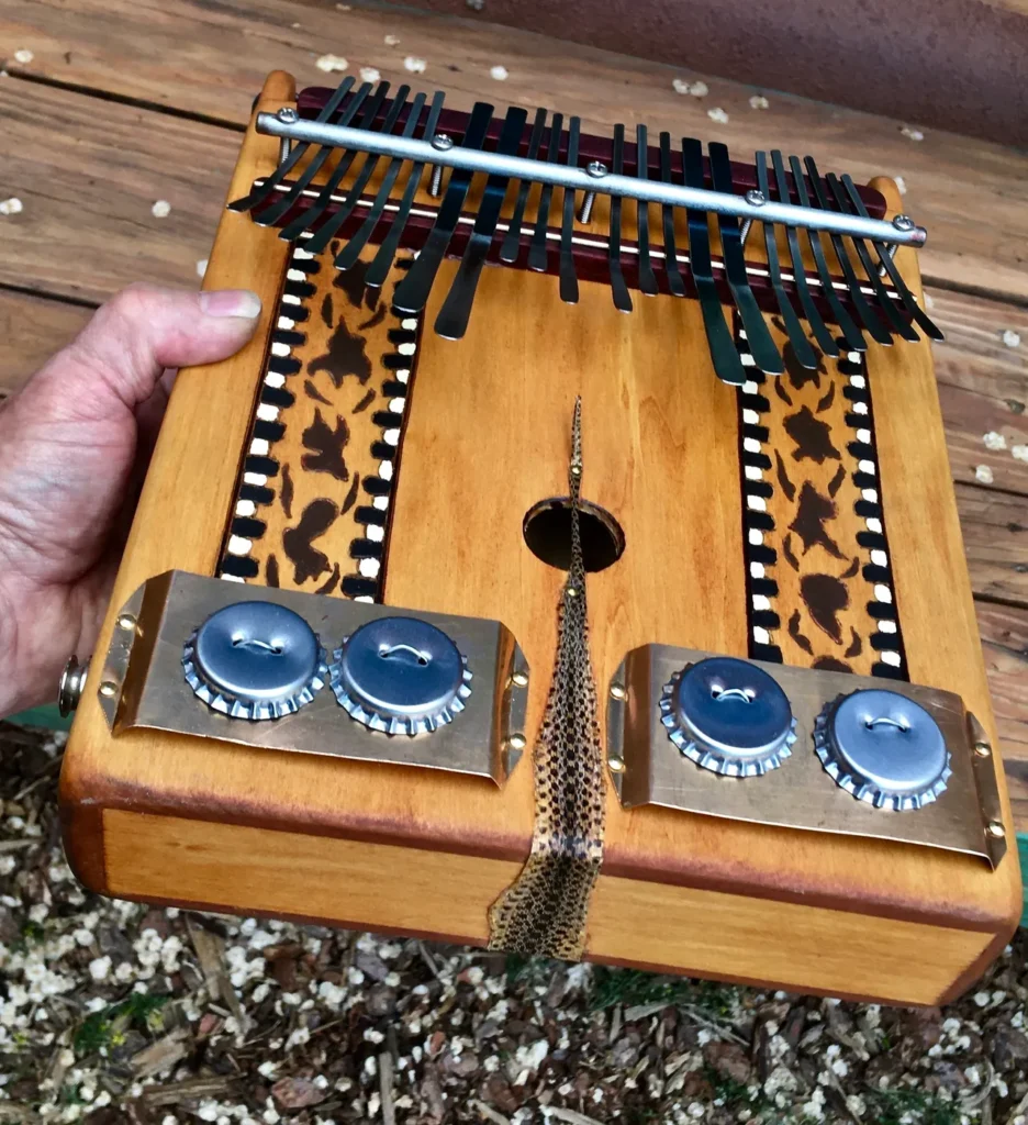 A person holding up a wooden lamellaphone.