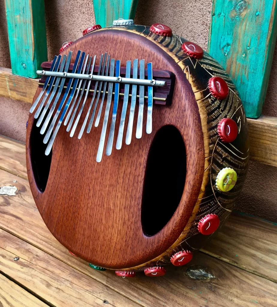 An Ilimba, an African harp, is sitting on a wooden table.