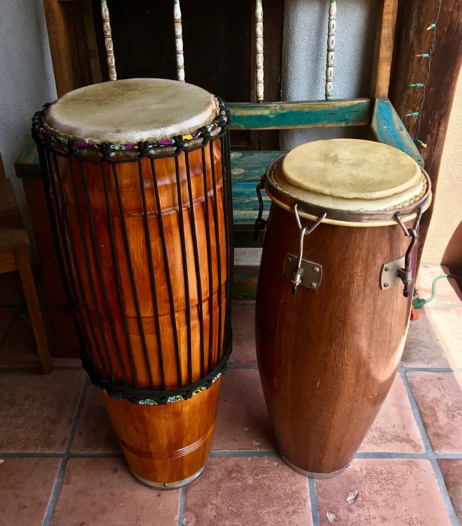 Two Kongoma drums sitting on a tile floor.