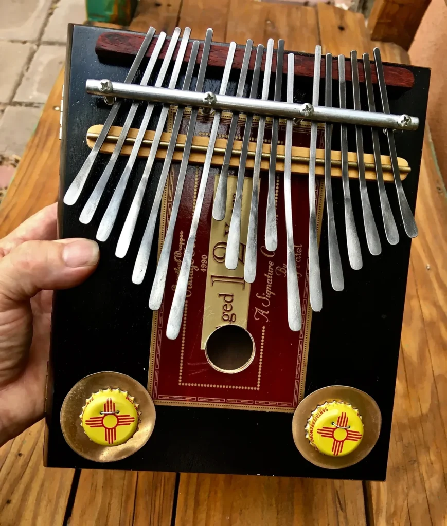 A person is holding a Ngoma, a wooden musical instrument used in African music.