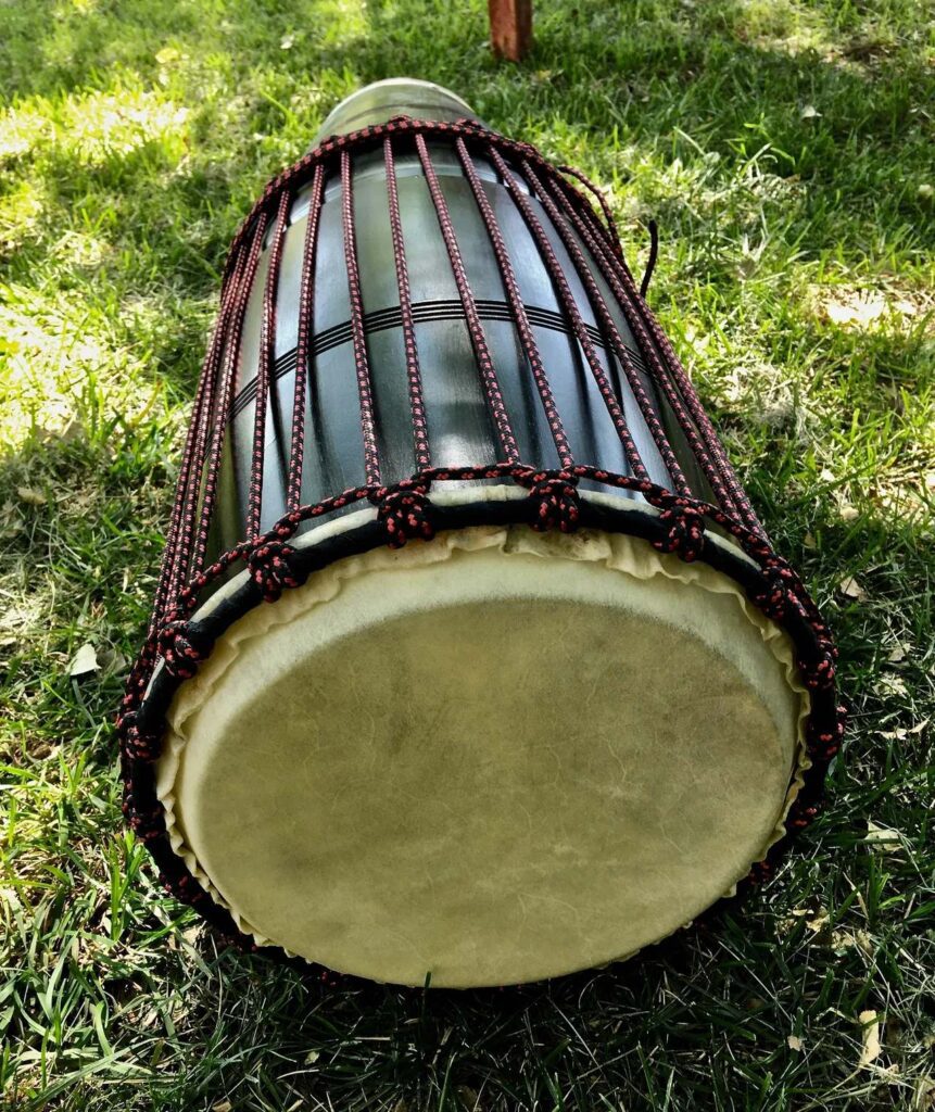 An ilimba sitting on the grass.