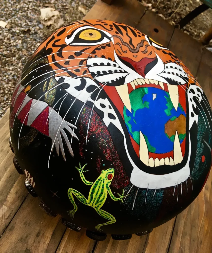 A tiger adorned with a stunningly painted frog.