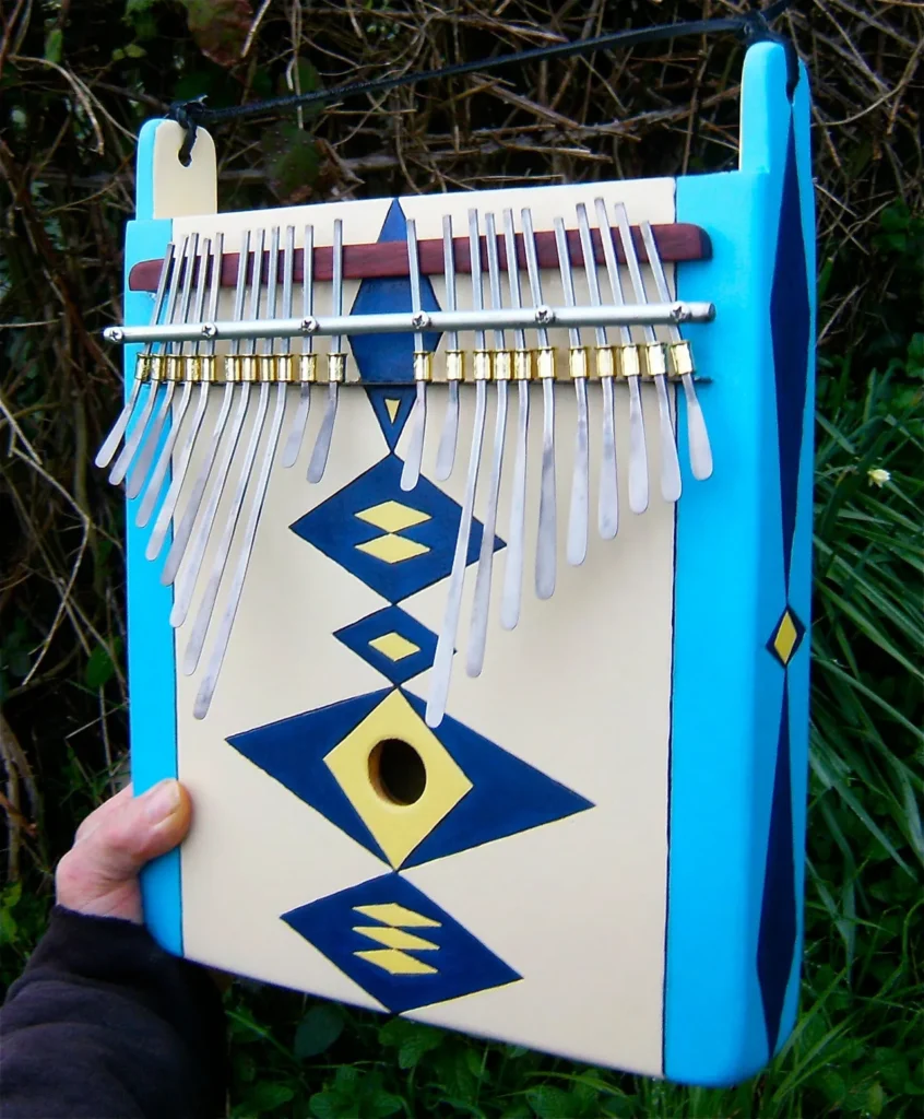 A person is holding a Ngoma, a blue and white African musical instrument.