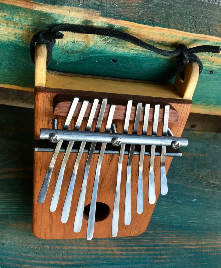 A wooden xylophone, inspired by Ngoma and African Music, sitting on top of a wooden table.