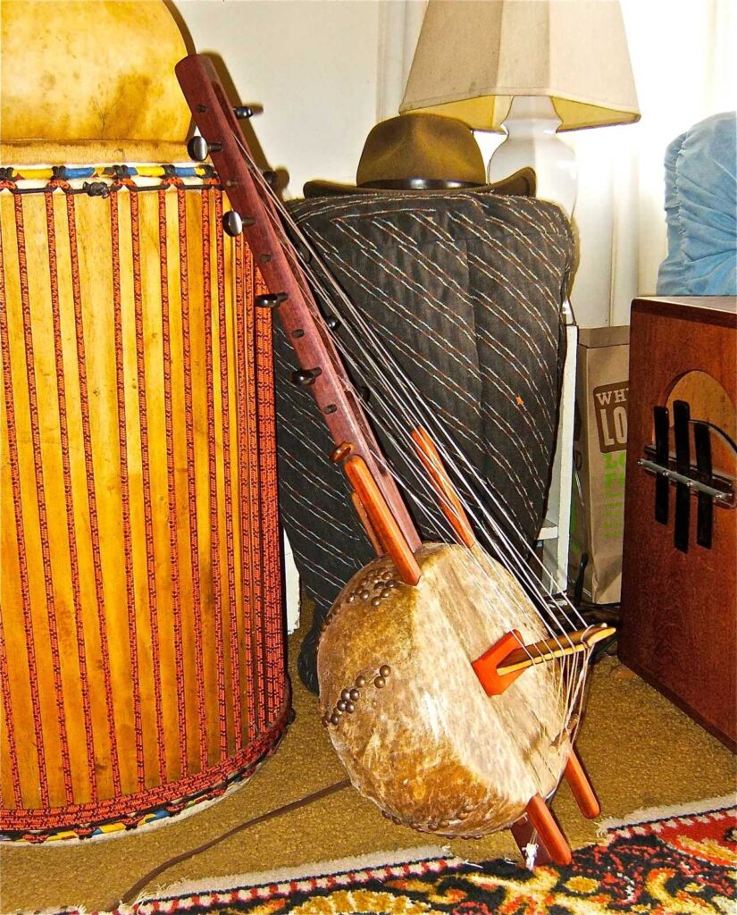 An Ngoma, a wooden instrument used in African music, placed on a rug beside a drum.