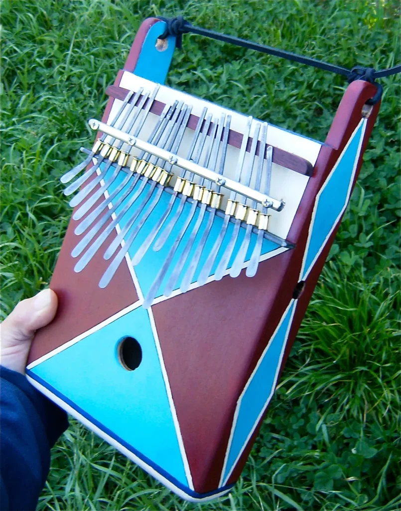 A person holding an African Ngoma, a blue and brown musical instrument.