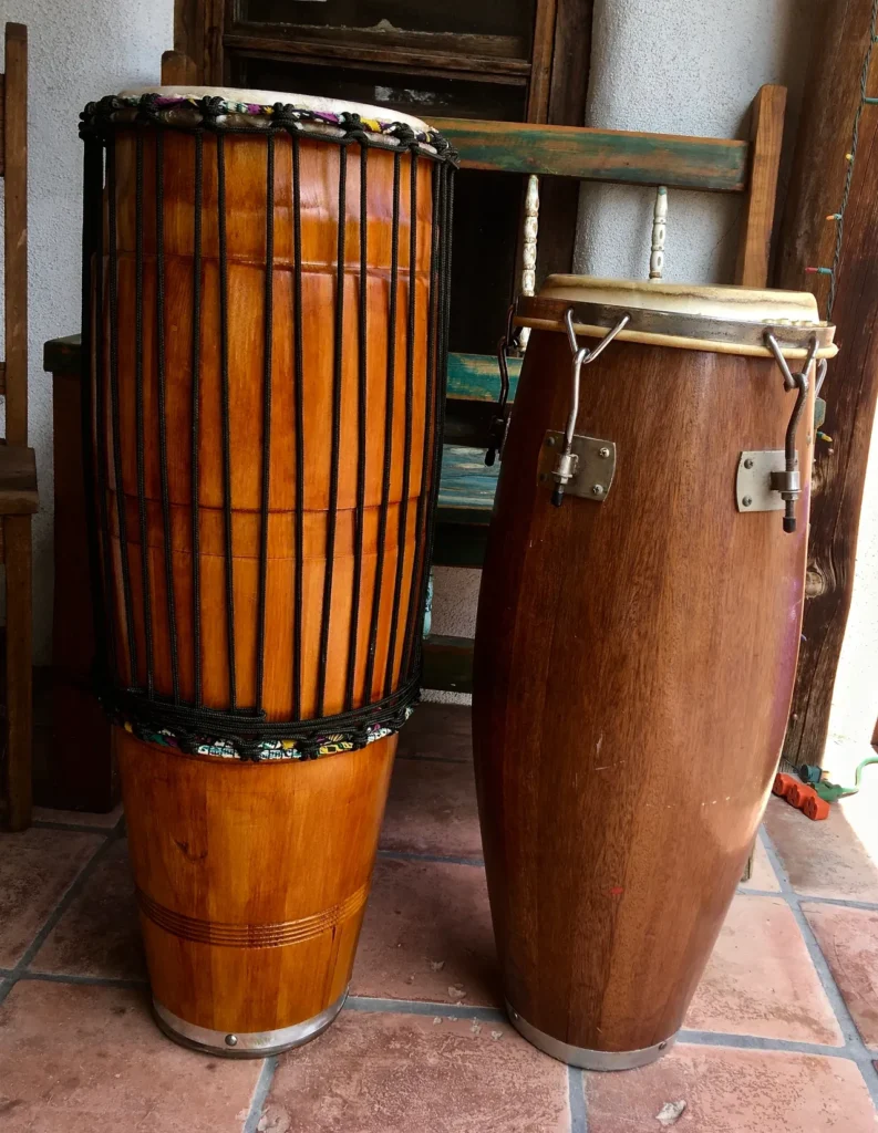 Two Ilimba congas sitting on a tile floor.