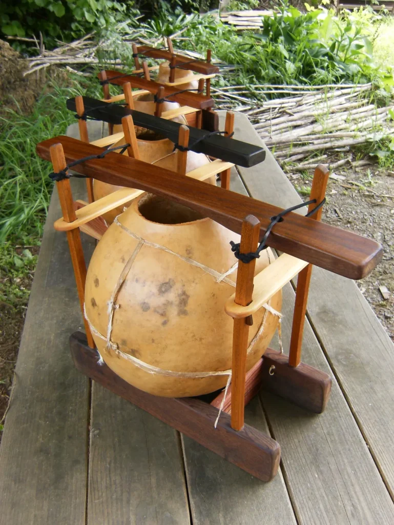 A wooden Lamellaphone table with a bunch of wooden pots on it.