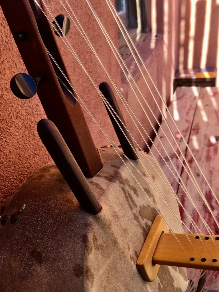 A Ngoma, a traditional African musical instrument, is delicately placed on a wooden bench.