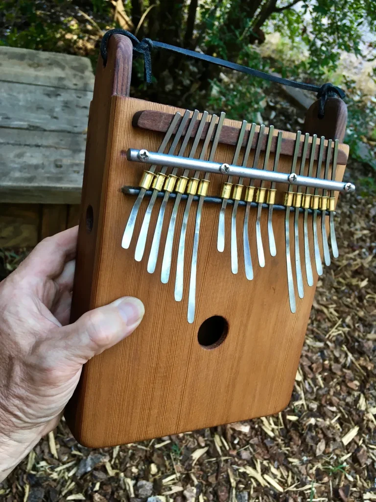 A person holding a wooden xylophone, playing Ngoma, traditional African music.