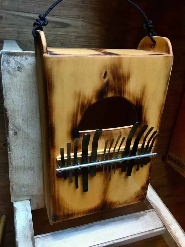 A Kalimba box with a knife hanging on it.