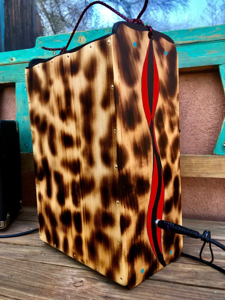 A wooden box with a leopard print on it, perfect for storing your Kalimba or African drum.