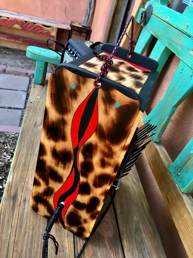 An African drum sitting on a wooden bench.