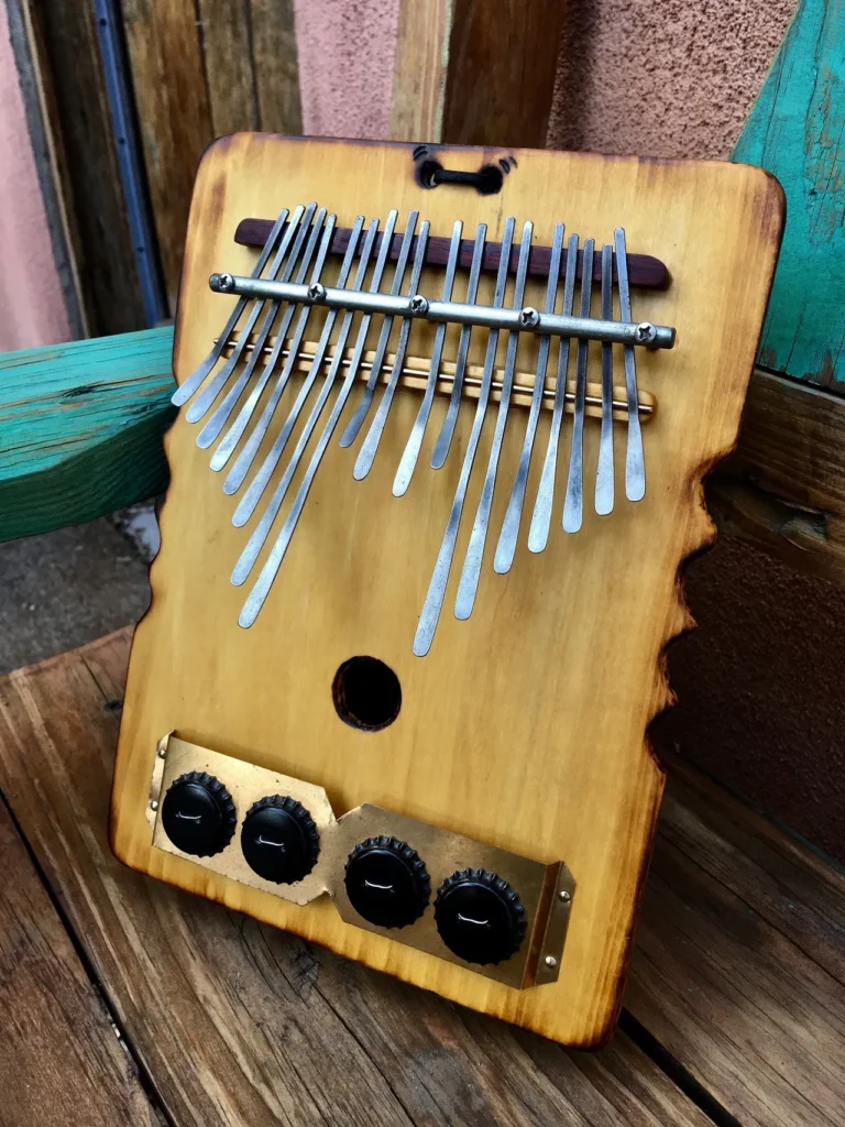 A Ngoma instrument is sitting on a wooden bench.