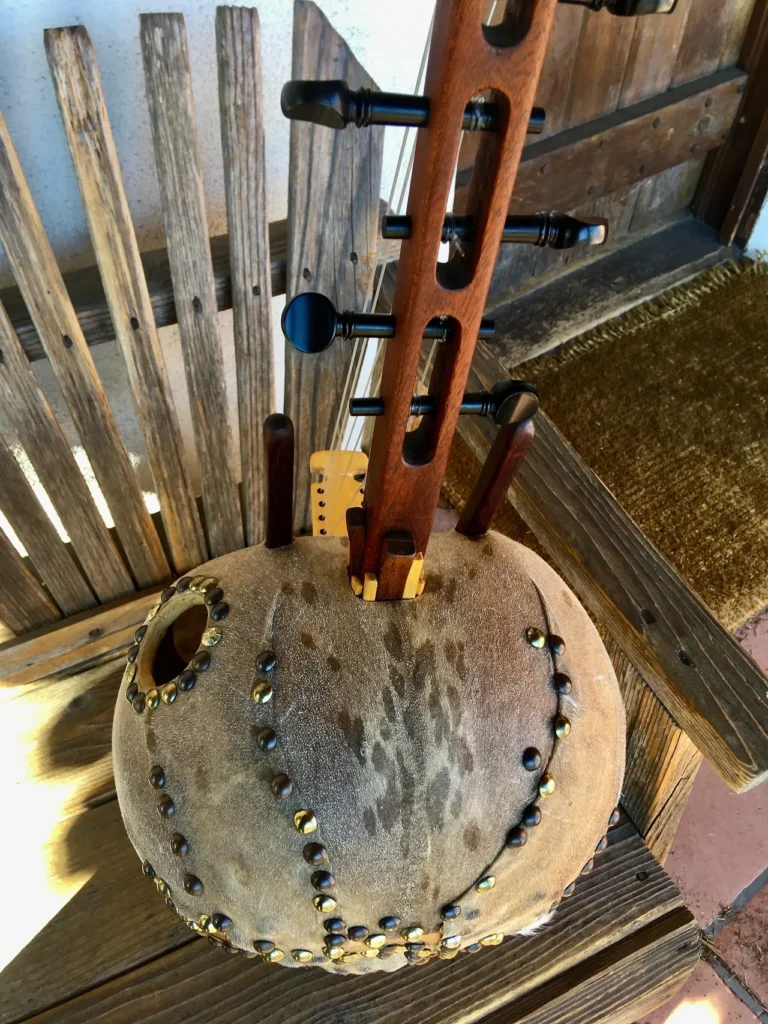 An Ngoma, a traditional African music instrument, sitting on top of a wooden bench.