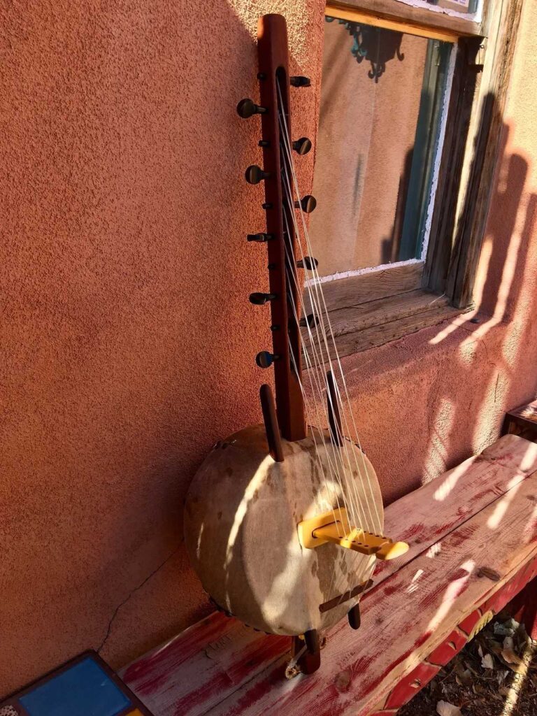 An Ngoma instrument sitting on a bench in front of a window.