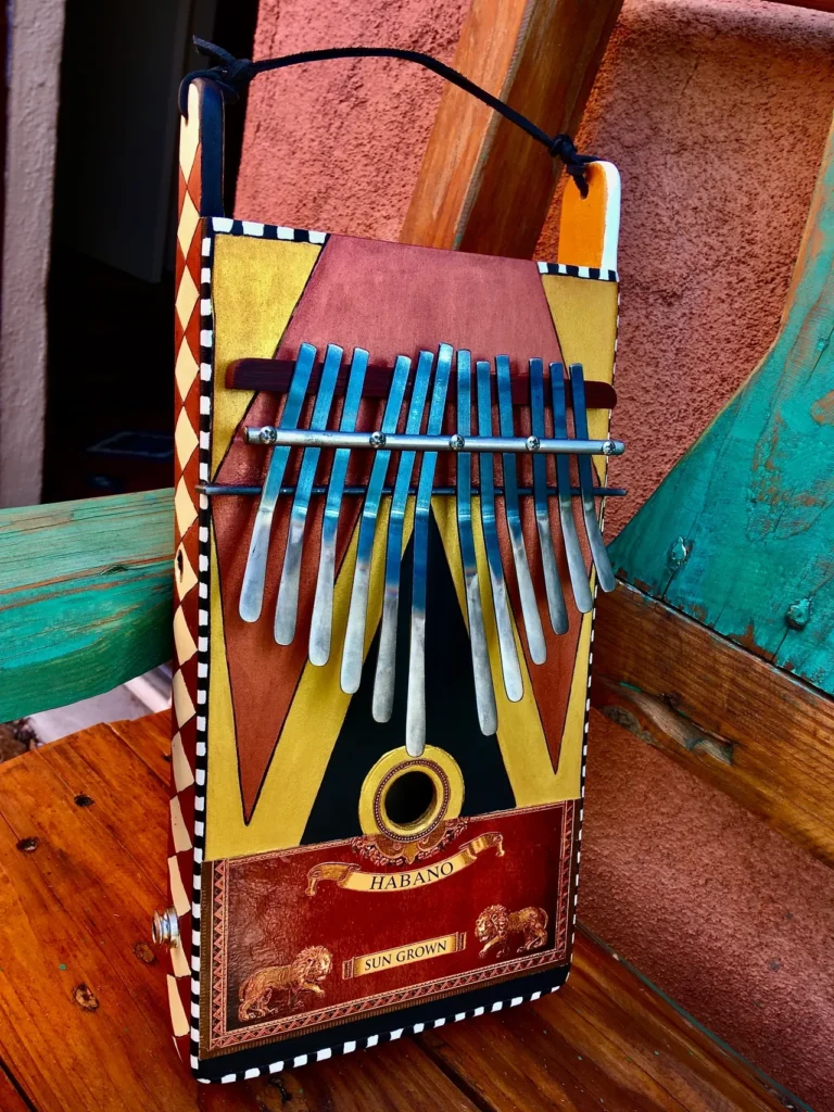 A wooden lamellaphone instrument is resting on top of a wooden bench.