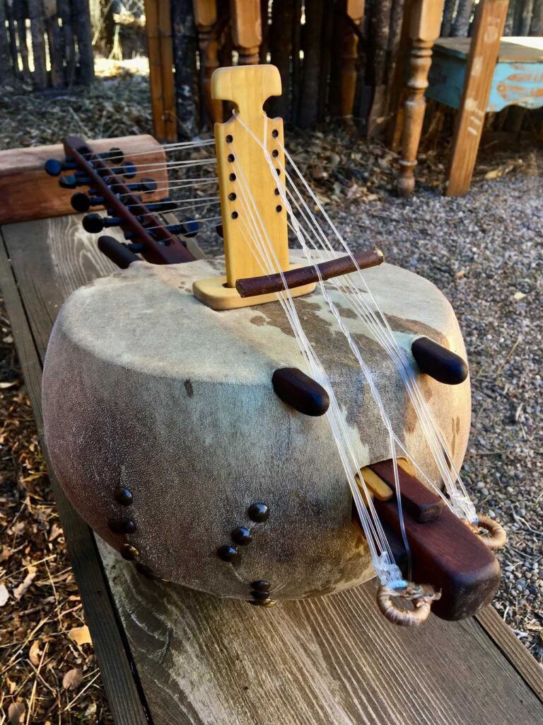 An Ngoma, a traditional African wooden instrument, is gently resting on a beautifully crafted wooden table.