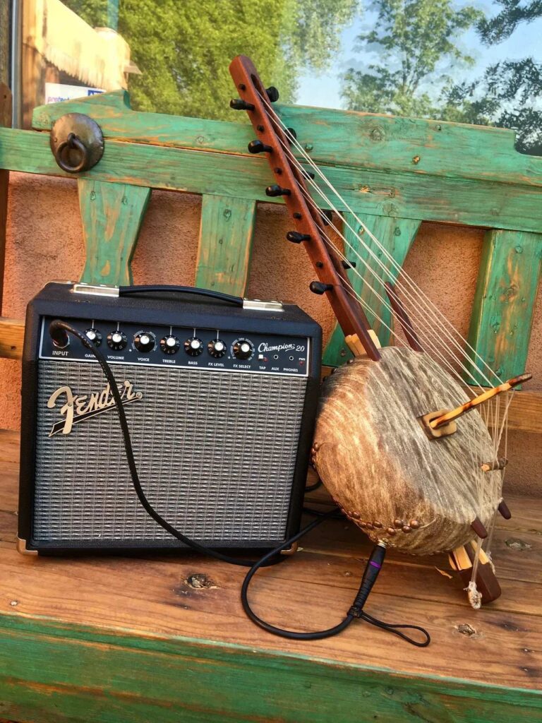 An Ngoma drum and a wooden xylophone sit on a wooden bench.