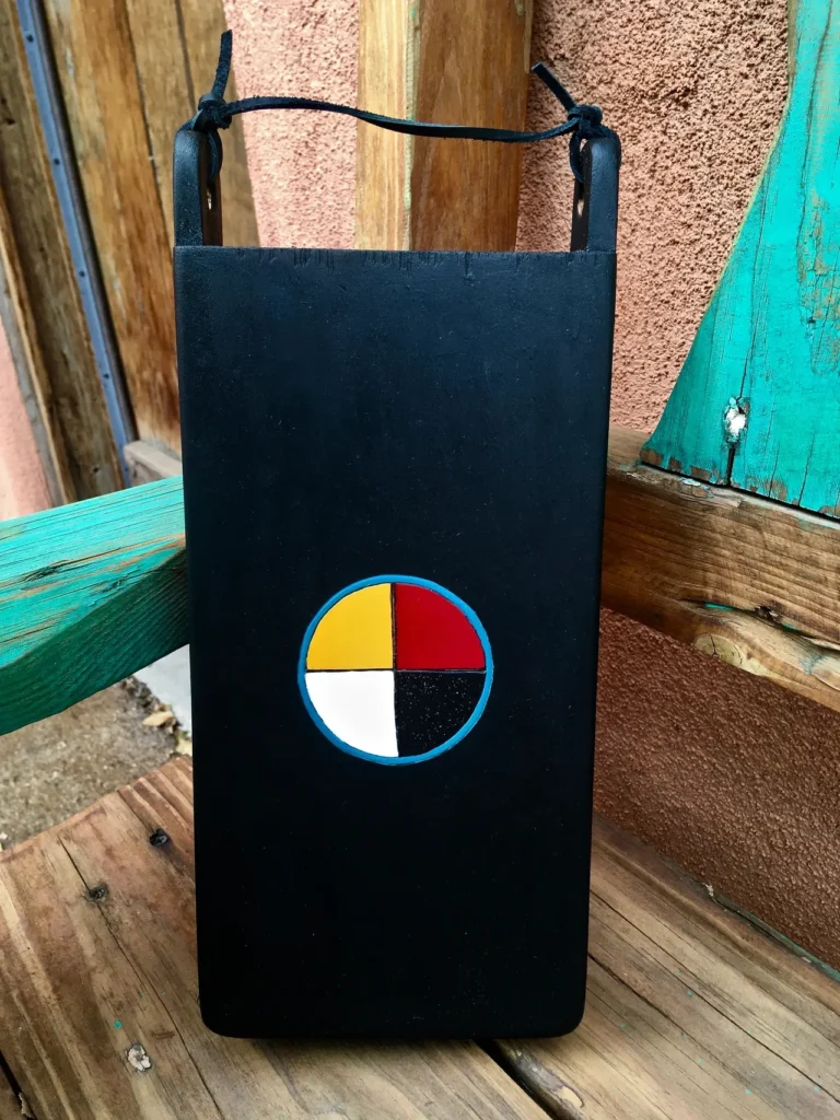 A Ngoma inspired black box with a red, yellow, and blue African Music design on it.