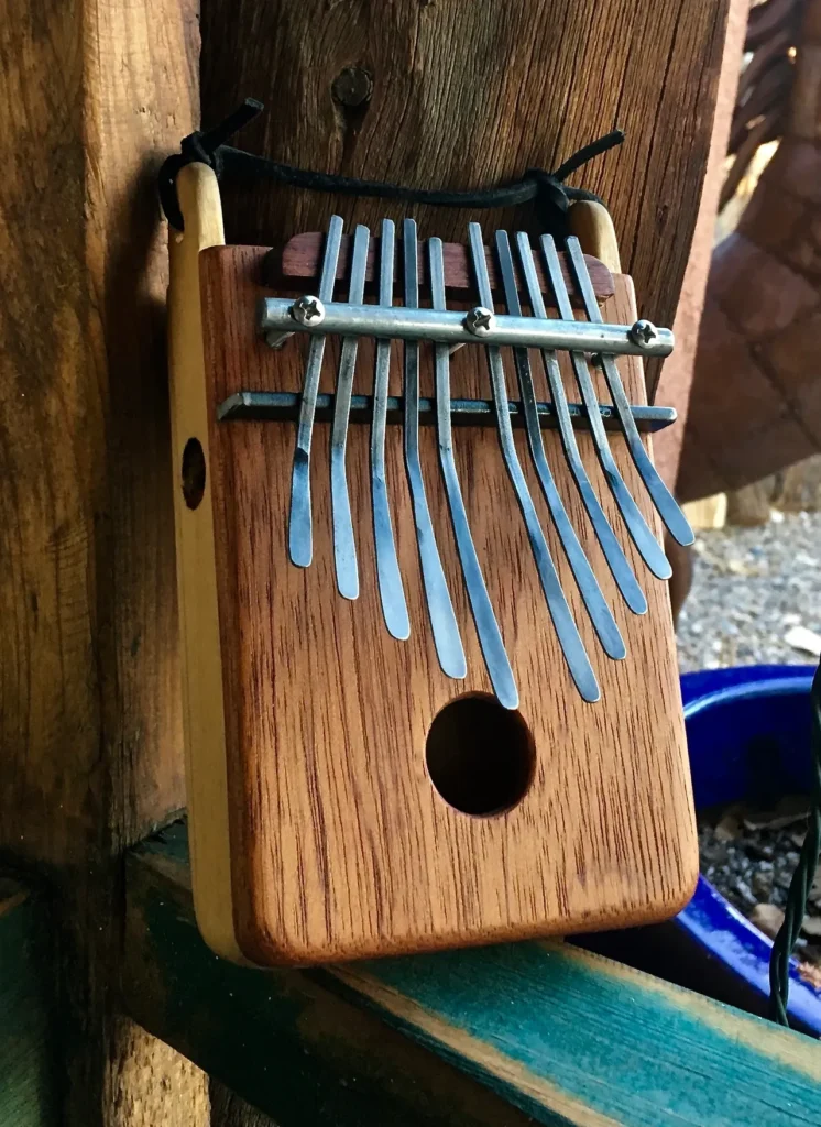 An Ngoma, a traditional African xylophone, hanging on a wooden fence.