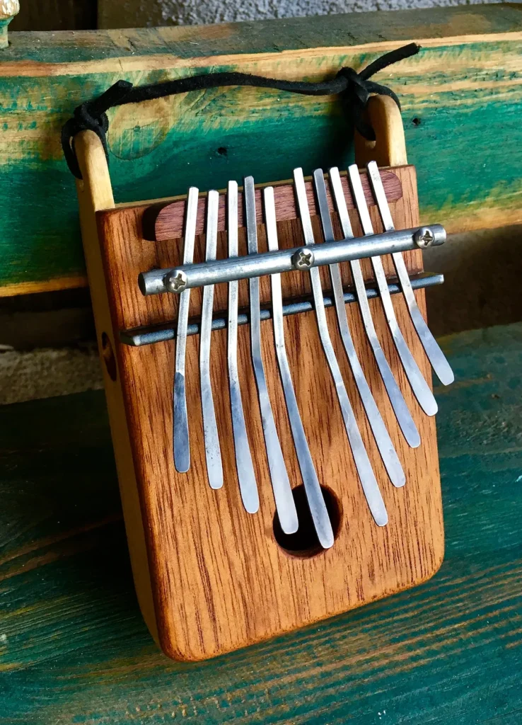 An African Ngoma, a wooden xylophone, sitting on a wooden bench.